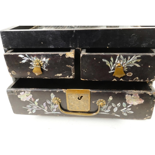 149 - A Japanese black lacquer vanity box with three drawers and mirror compartment extensively inlaid wit... 