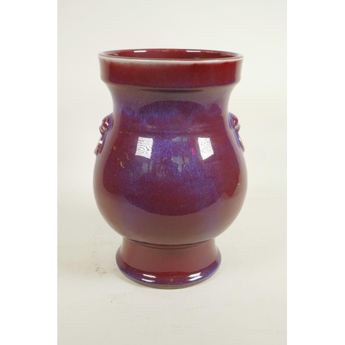 15 - A Chinese Jun ware pottery vase with two mask handles, 10½