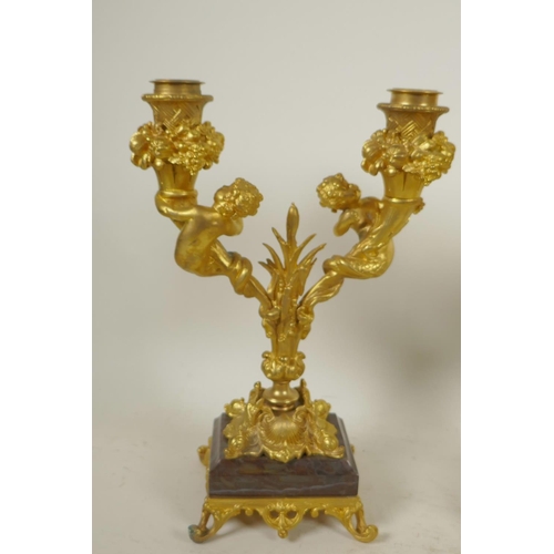 151 - A pair of ormolu two branch table candelabra, the sconces surrounded by bowls of fruit, and the stem... 