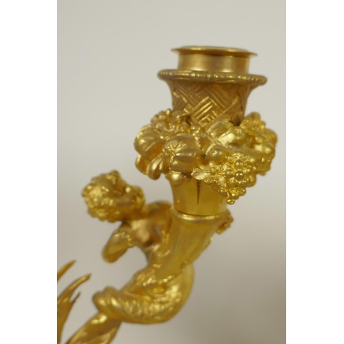 151 - A pair of ormolu two branch table candelabra, the sconces surrounded by bowls of fruit, and the stem... 