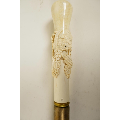 171 - A hardwood walking cane with bone handle carved as birds on a fruiting vine, 39