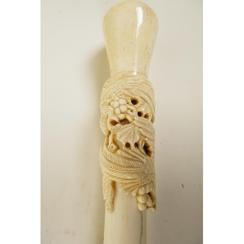 171 - A hardwood walking cane with bone handle carved as birds on a fruiting vine, 39