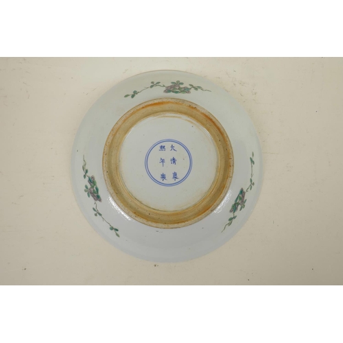 175 - A Chinese famille verte porcelain charger, with a figure in front of a screen, 6 character mark to b... 