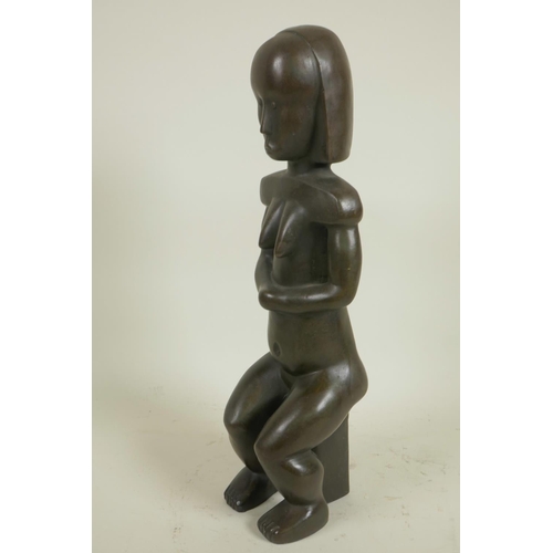 176 - A stylised bronze figure of a seated African woman, 14