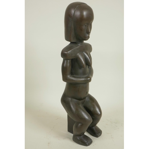 176 - A stylised bronze figure of a seated African woman, 14