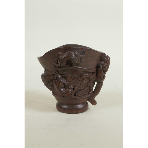 18 - A Chinese carved bamboo libation cup decorated with climbing kylin, seal mark to base, 3