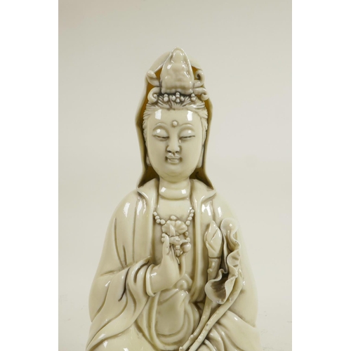 183 - A Chinese blanc de chine porcelain figure of Quan Yin seated on a lotus throne, impressed marks vers... 