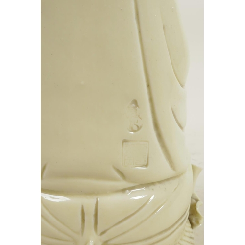 183 - A Chinese blanc de chine porcelain figure of Quan Yin seated on a lotus throne, impressed marks vers... 