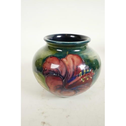 186 - Two Moorcroft vases, a mid C20th Moorcroft 'Hibiscus' pattern squat vase, tube-lined flowers and fol... 