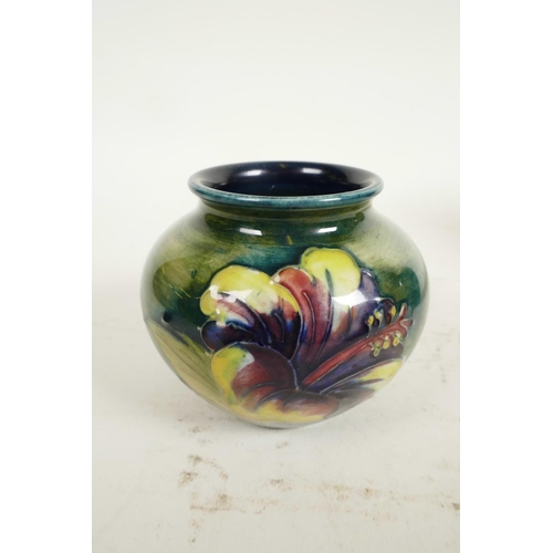 186 - Two Moorcroft vases, a mid C20th Moorcroft 'Hibiscus' pattern squat vase, tube-lined flowers and fol... 