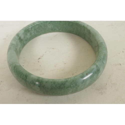 191 - A Chinese green hardstone bangle, 3