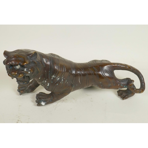 196 - A bronze figure of a roaring tiger, 13