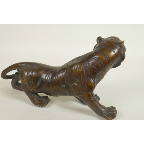 196 - A bronze figure of a roaring tiger, 13