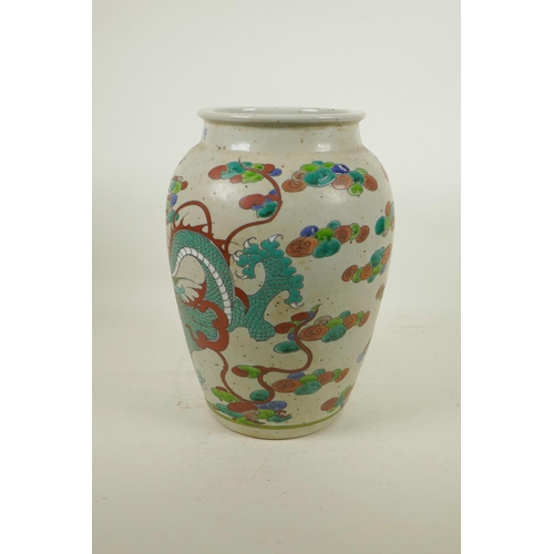 215 - A Chinese polychrome pottery jar decorated with a dragon, 6 character mark to lip, 12