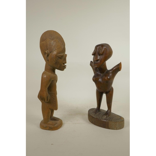 217 - An African carved hardwood tribal figure, and another, one armless, 13