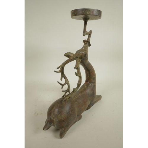 218 - An archaic style Chinese bronze figure of a deer supporting a candle/bowl stand, 13