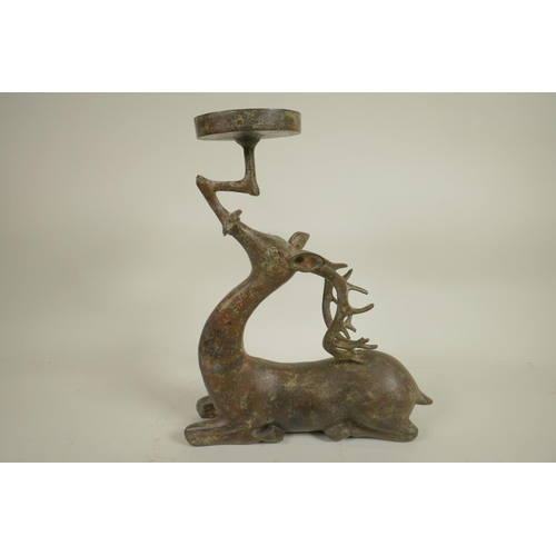 218 - An archaic style Chinese bronze figure of a deer supporting a candle/bowl stand, 13