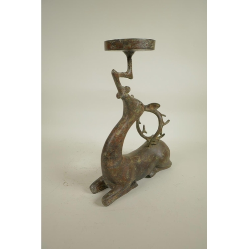 218 - An archaic style Chinese bronze figure of a deer supporting a candle/bowl stand, 13