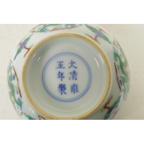 226 - A Chinese carved doucai porcelain rice bowl with enamelled dragon decoration, 6 character mark to ba... 