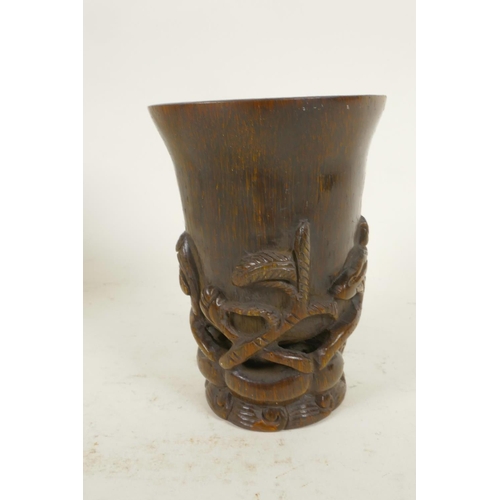 24 - A Chinese horn libation cup carved with flowering lotus, 4¼