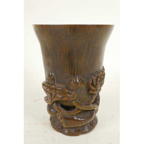 24 - A Chinese horn libation cup carved with flowering lotus, 4¼