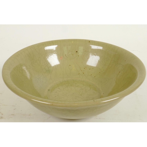 240 - A Chinese celadon glazed porcelain bowl with central floral decoration, 7