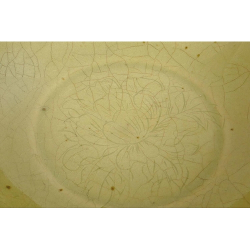 240 - A Chinese celadon glazed porcelain bowl with central floral decoration, 7