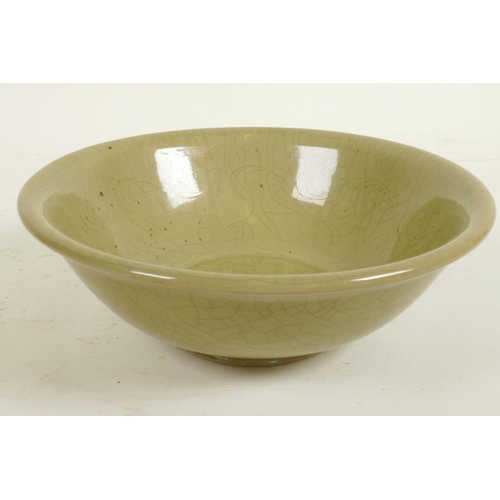 240 - A Chinese celadon glazed porcelain bowl with central floral decoration, 7