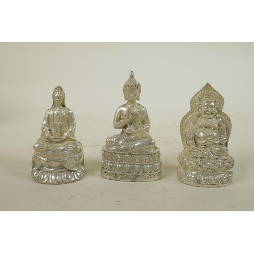 243 - Three Chinese white metal cast figures of Buddha and Quan Yin, largest 3½