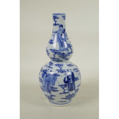 255 - A Chinese blue and white porcelain double gourd vase decorated with the Eight Immortals, 4 character... 