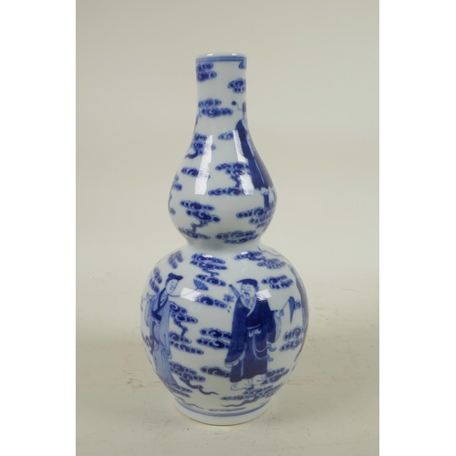 255 - A Chinese blue and white porcelain double gourd vase decorated with the Eight Immortals, 4 character... 