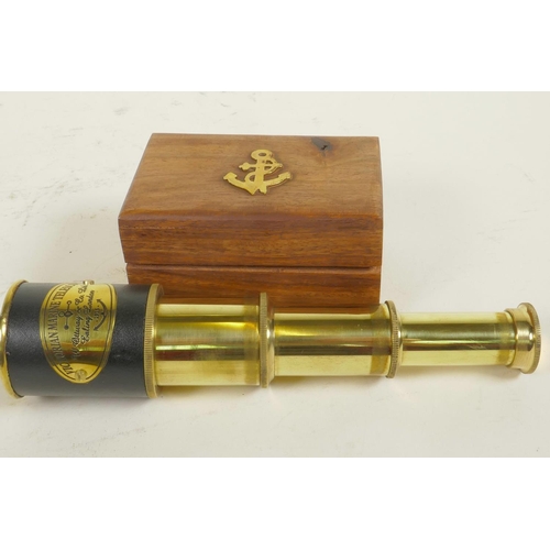 256 - A small brass three draw telescope in a hardwood box, 7