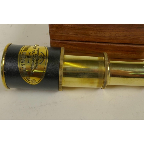 256 - A small brass three draw telescope in a hardwood box, 7