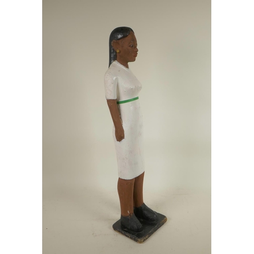 257 - An African carved and painted wood figure of a healthworker, 23