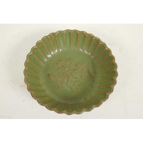 261 - A Chinese green glazed porcelain bowl of ribbed form, the centre decorated with a flowering tree, 5