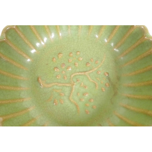 261 - A Chinese green glazed porcelain bowl of ribbed form, the centre decorated with a flowering tree, 5