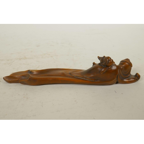 265 - A Chinese boxwood incense stick holder in the form of a reclining sage, 8