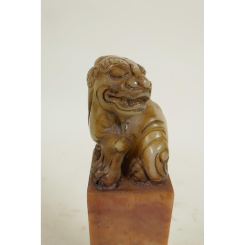 274 - A square section Chinese carved soapstone seal, the top carved as a fo dog, 6