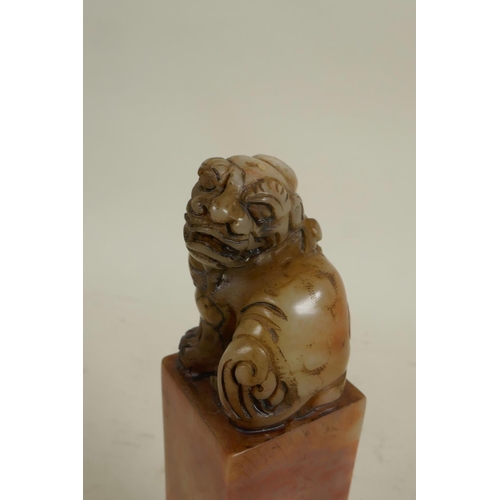 274 - A square section Chinese carved soapstone seal, the top carved as a fo dog, 6