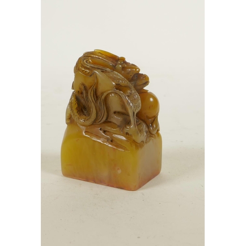 275 - A Chinese carved soapstone seal with dragon and flaming pearl decoration, 2