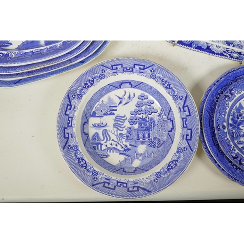 276 - A C19th blue and white meat plate with a boatman on a river, within a wild rose border, possibly Rog... 