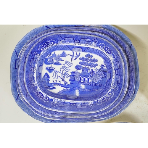 276 - A C19th blue and white meat plate with a boatman on a river, within a wild rose border, possibly Rog... 