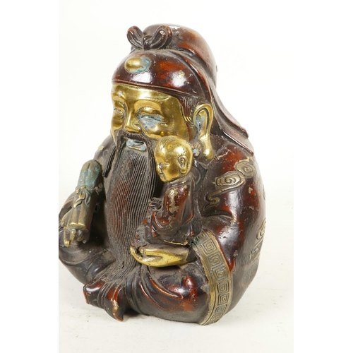 279 - A Chinese gilt and red bronze figure of a bearded Lohan with small child in his arm, 9