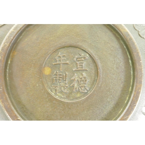 28 - A Chinese bronze dish with raised kylin and flaming pearl decoration, impressed 4 character mark to ... 