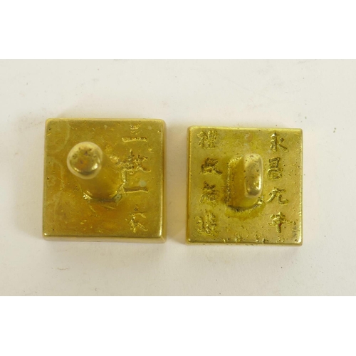 280 - A Chinese gilt metal seal of square form and another similar, the tops with character inscriptions, ... 