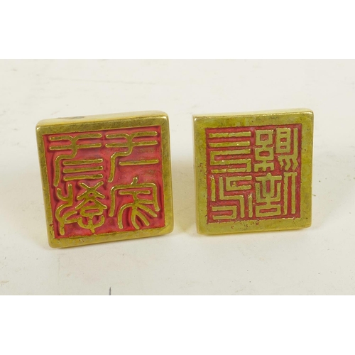 280 - A Chinese gilt metal seal of square form and another similar, the tops with character inscriptions, ... 