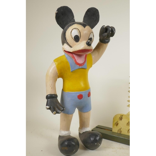 282 - A carved and painted wood figure of a stylised Mickey Mouse, and a painted wood duck plaque, 16