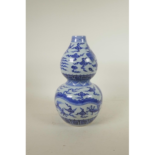 283 - A Chinese blue and white porcelain double gourd vase with phoenix and dragon decoration, 6 character... 