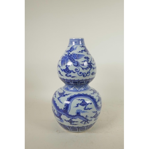 283 - A Chinese blue and white porcelain double gourd vase with phoenix and dragon decoration, 6 character... 