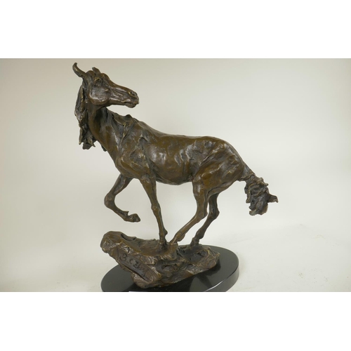 286 - A bronze figure of a horse standing on a rock, signed, 16½